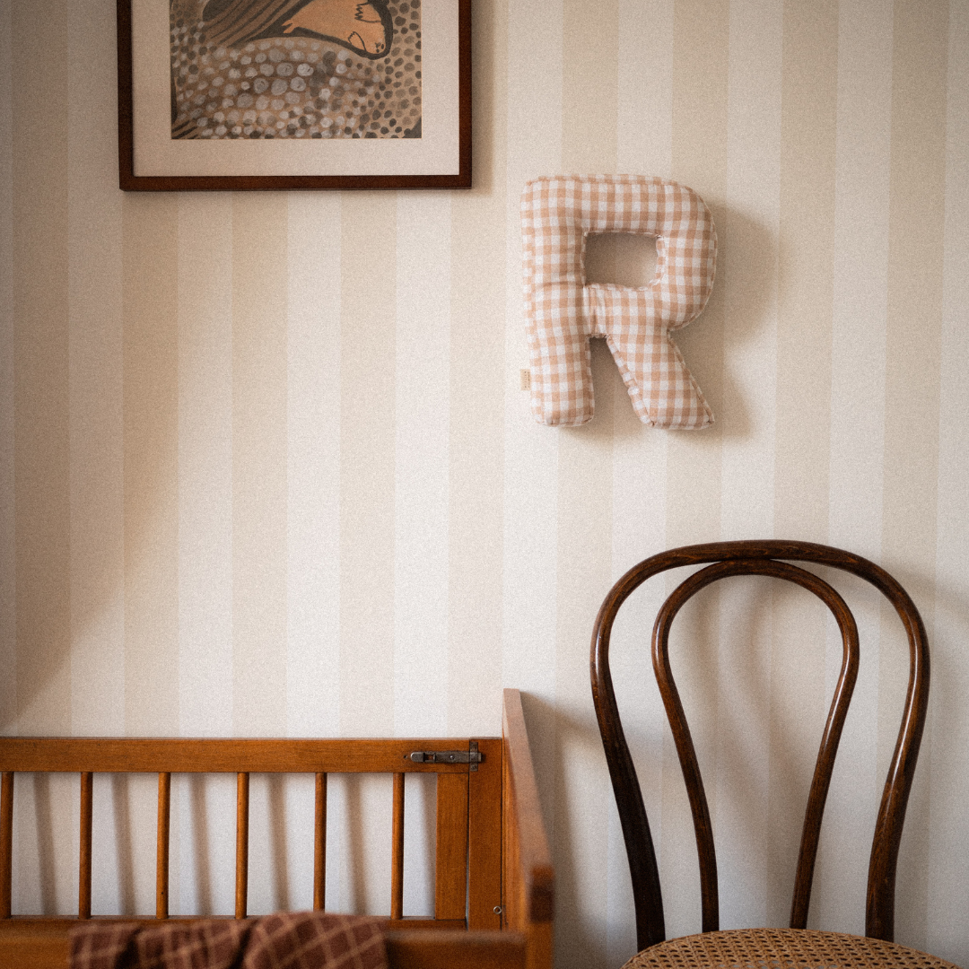 Een geruite letter voor aan de muur